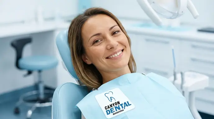 Smiling woman sitting in dental chair at clinic